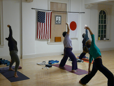 the class practices triangle pose